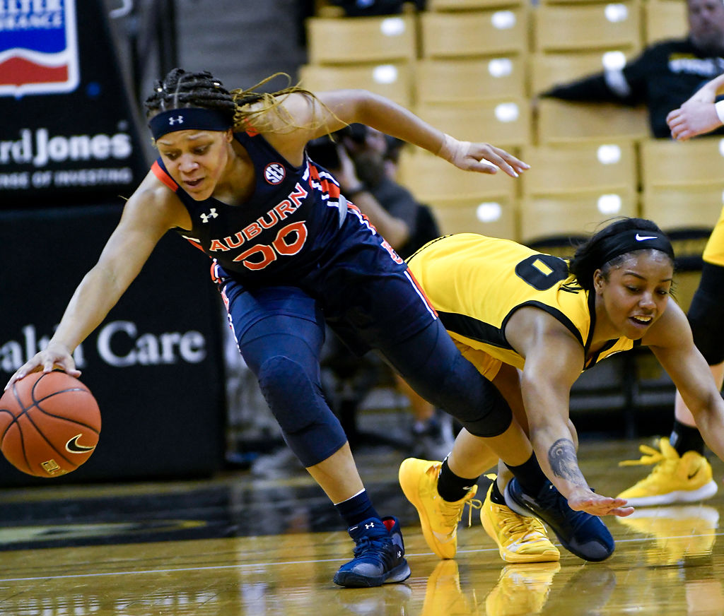 Auburn's Morgan Robinson-Nwagwu dribbles the ball while Missouri's Nadia Green dives after her
